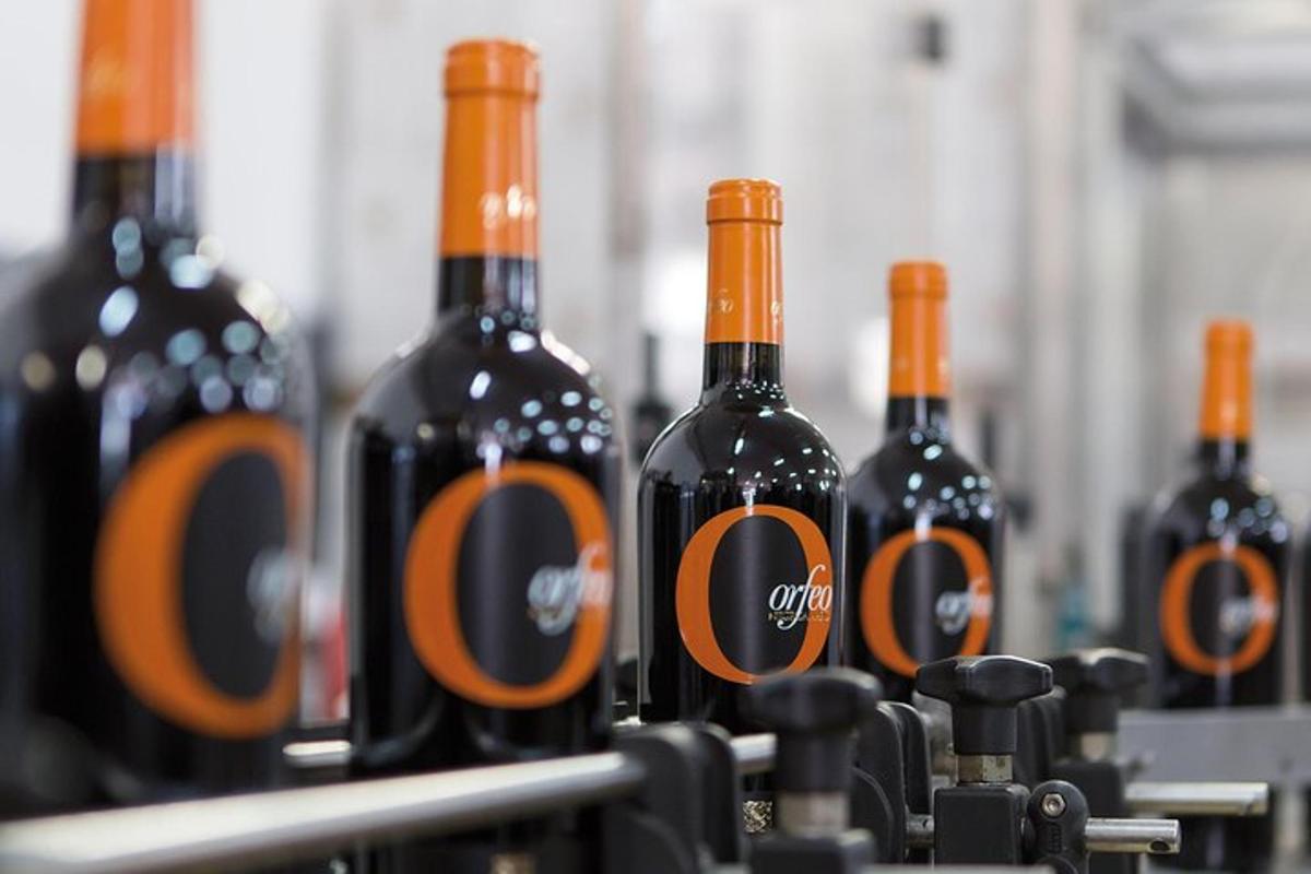 a row of bottles of wine on a machine
