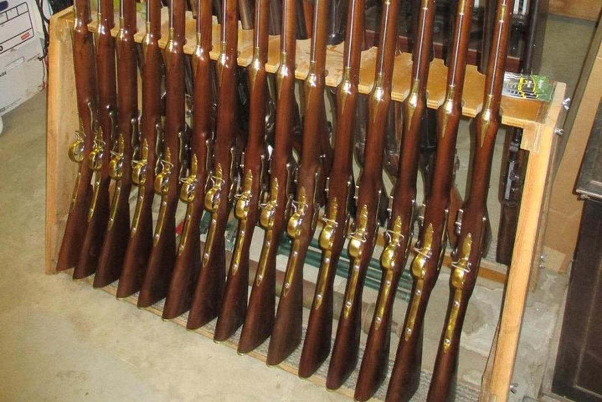 a bunch of wooden baseball bats in a rack
