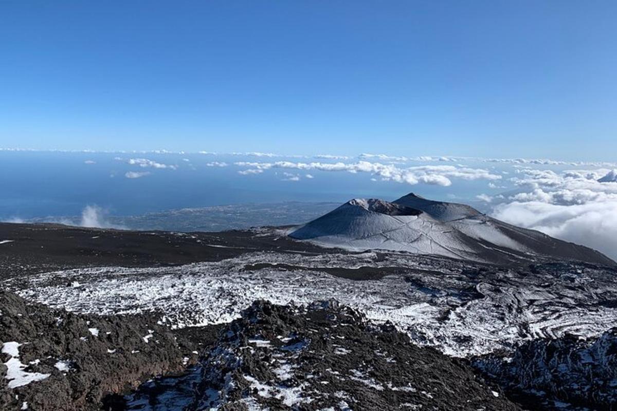 a view of a mountain in the sky with clouds