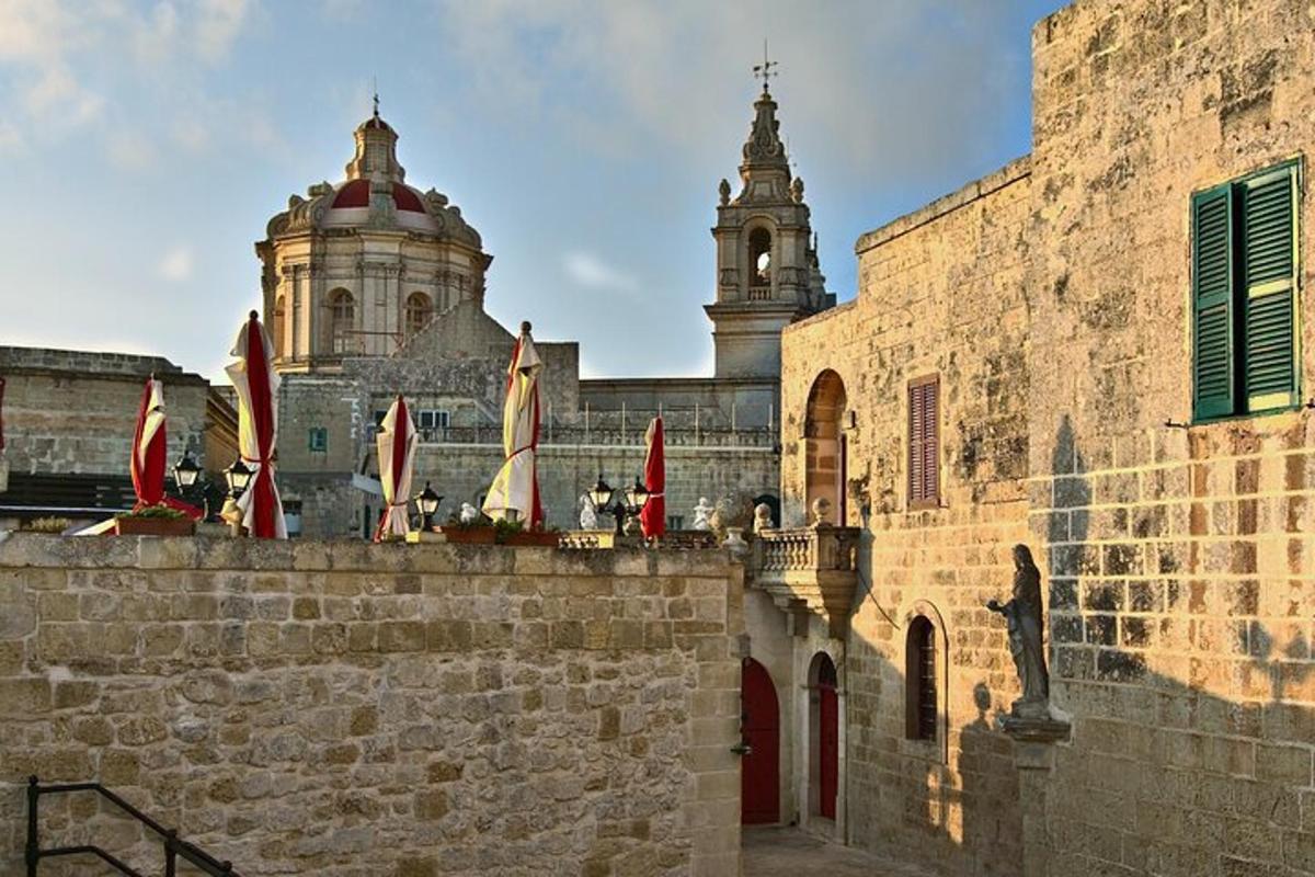 a stone building with a clock tower in the background