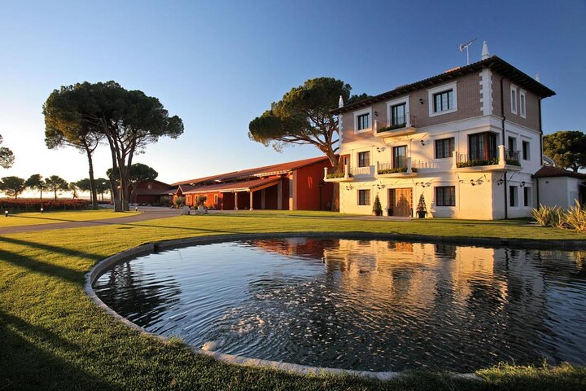 a house with a pond in front of a building
