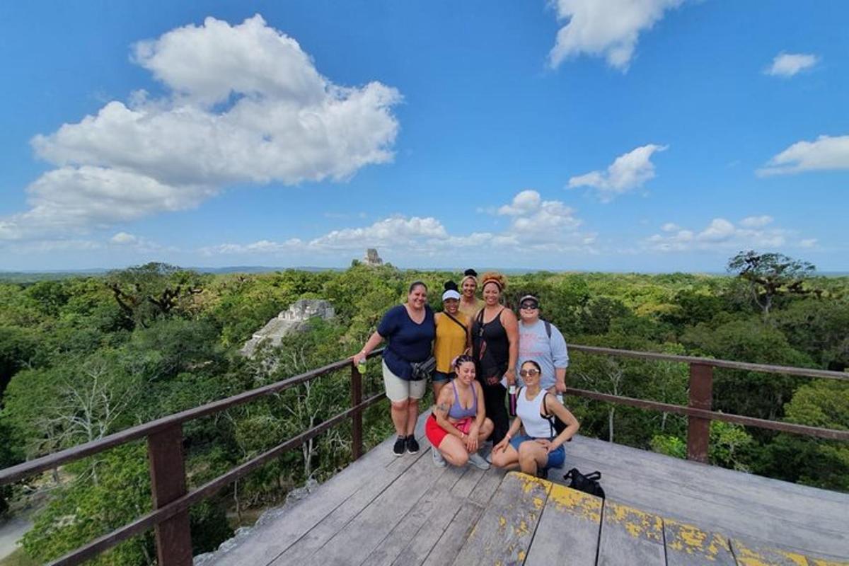 a group of people posing for a picture on a boardwalk