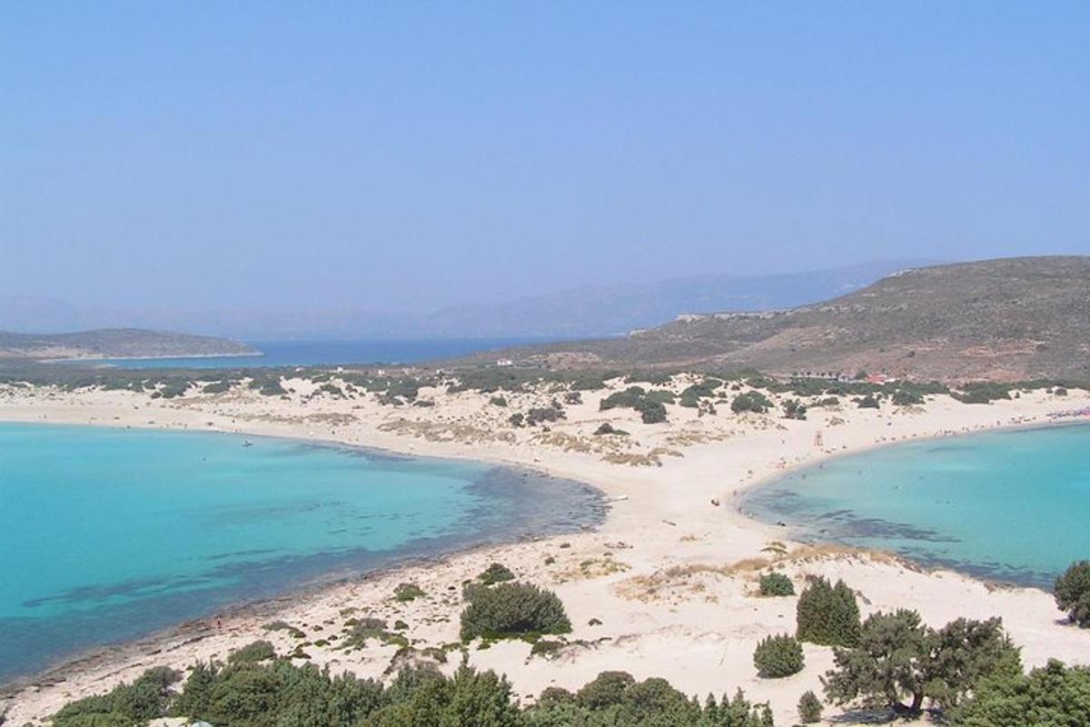 an aerial view of a beach with blue water