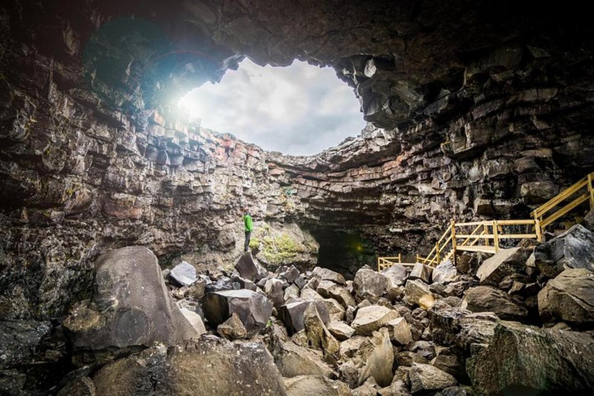 a cave with a person standing inside of it