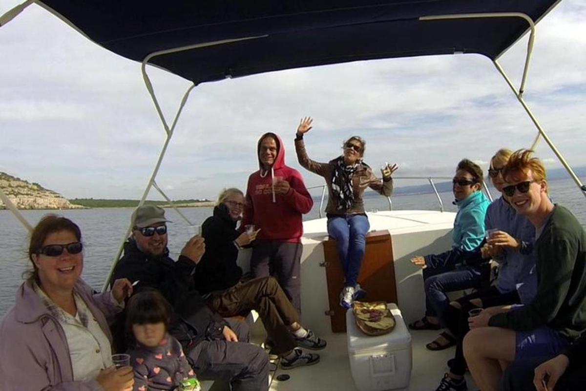 a group of people sitting on the back of a boat