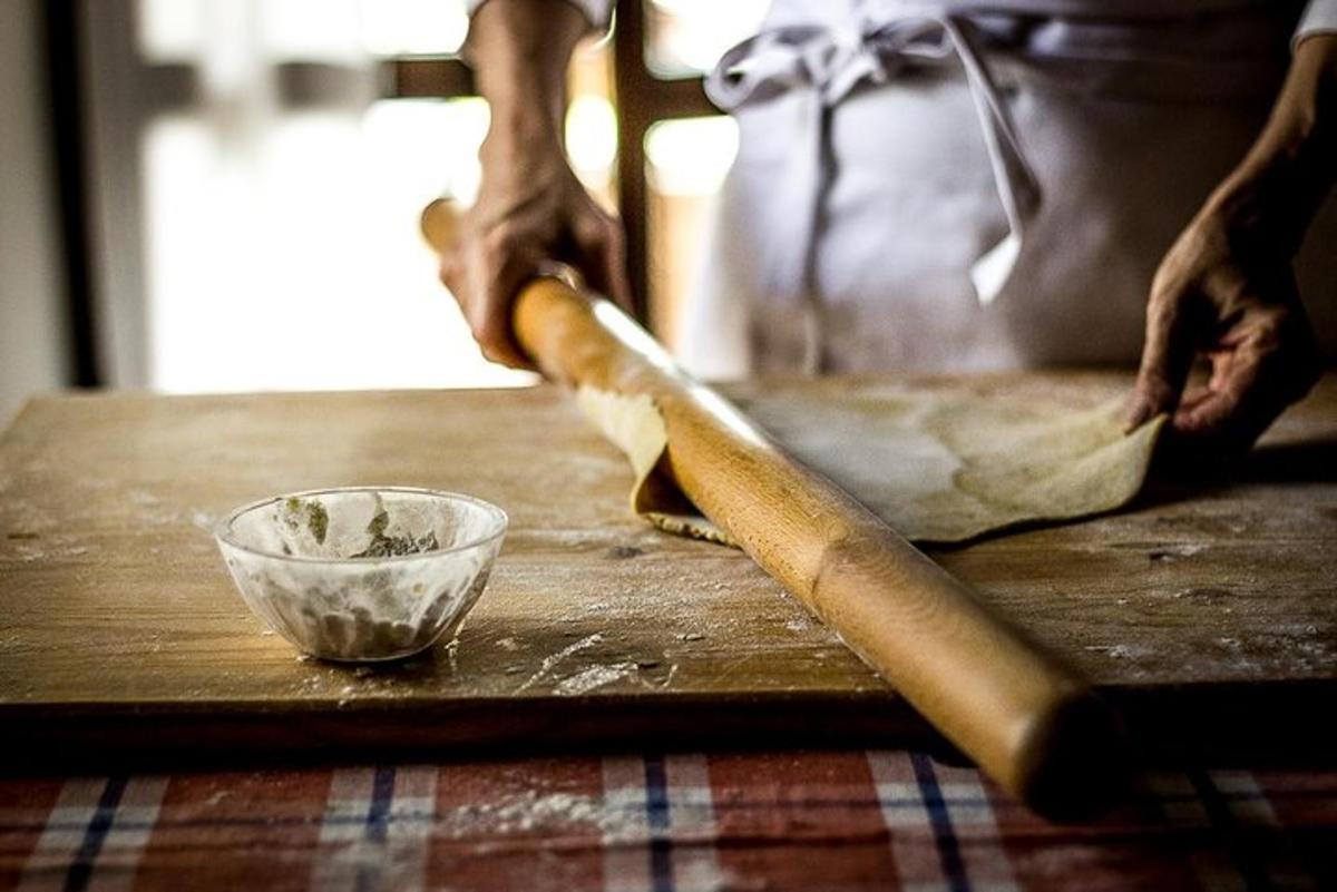 a person holding a knife and a bowl on a table