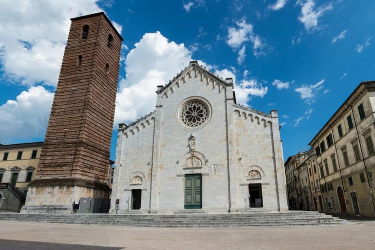 a white church with a clock tower in a city