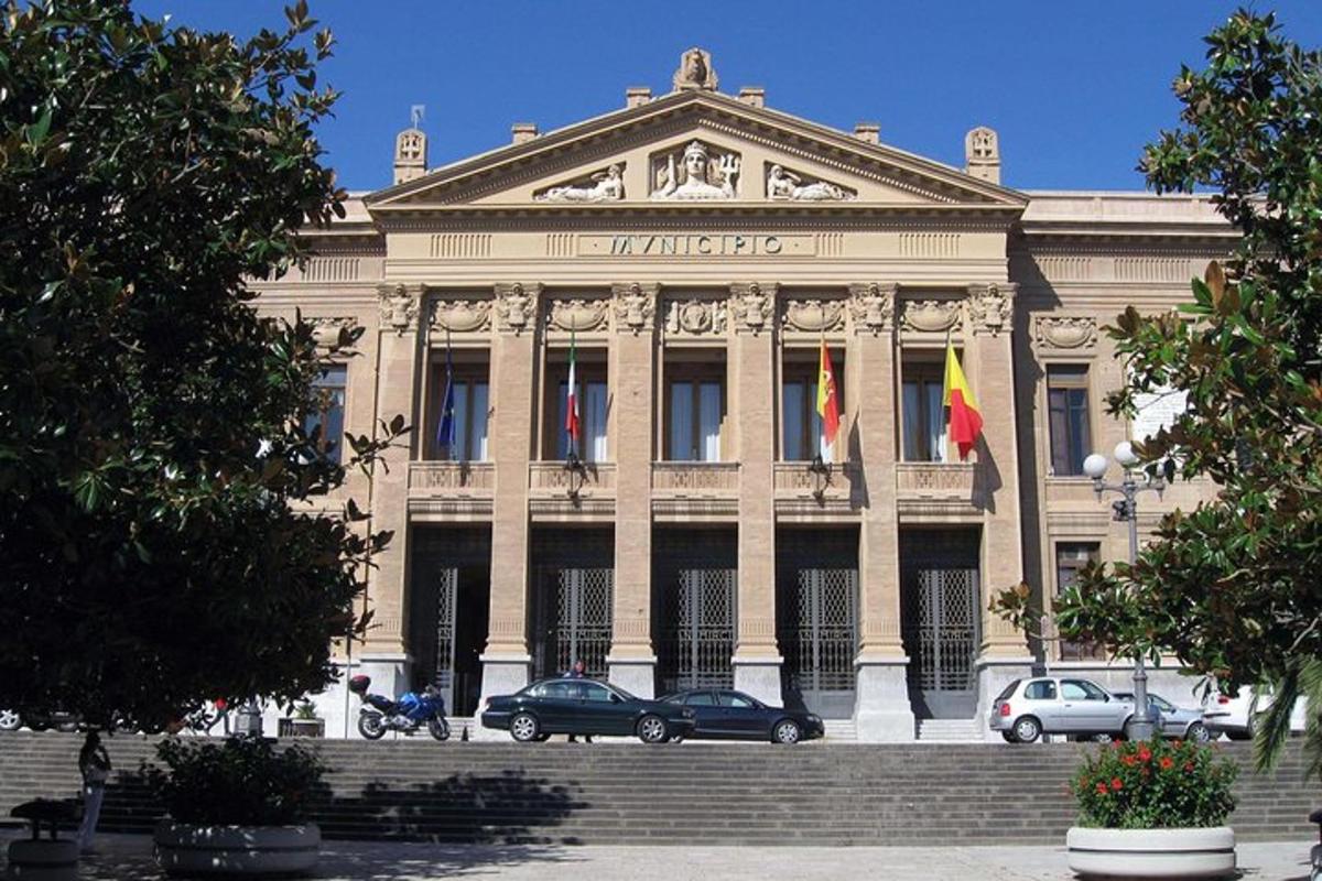 a large building with flags in front of it