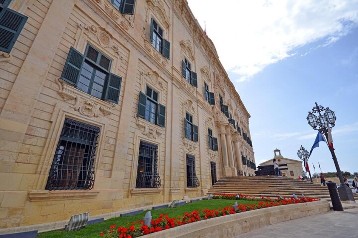 a large building with red flowers in front of it