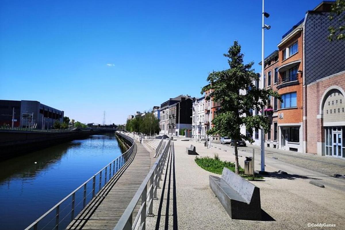 a bridge over a river with benches next to a building
