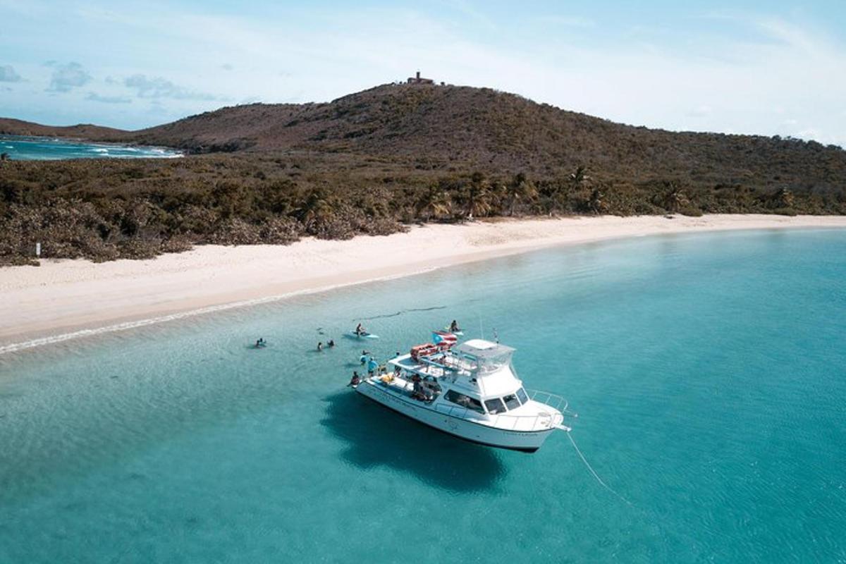 a boat in the water next to a beach