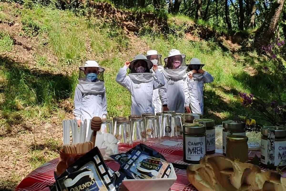 a group of people dressed in white standing around a picnic table
