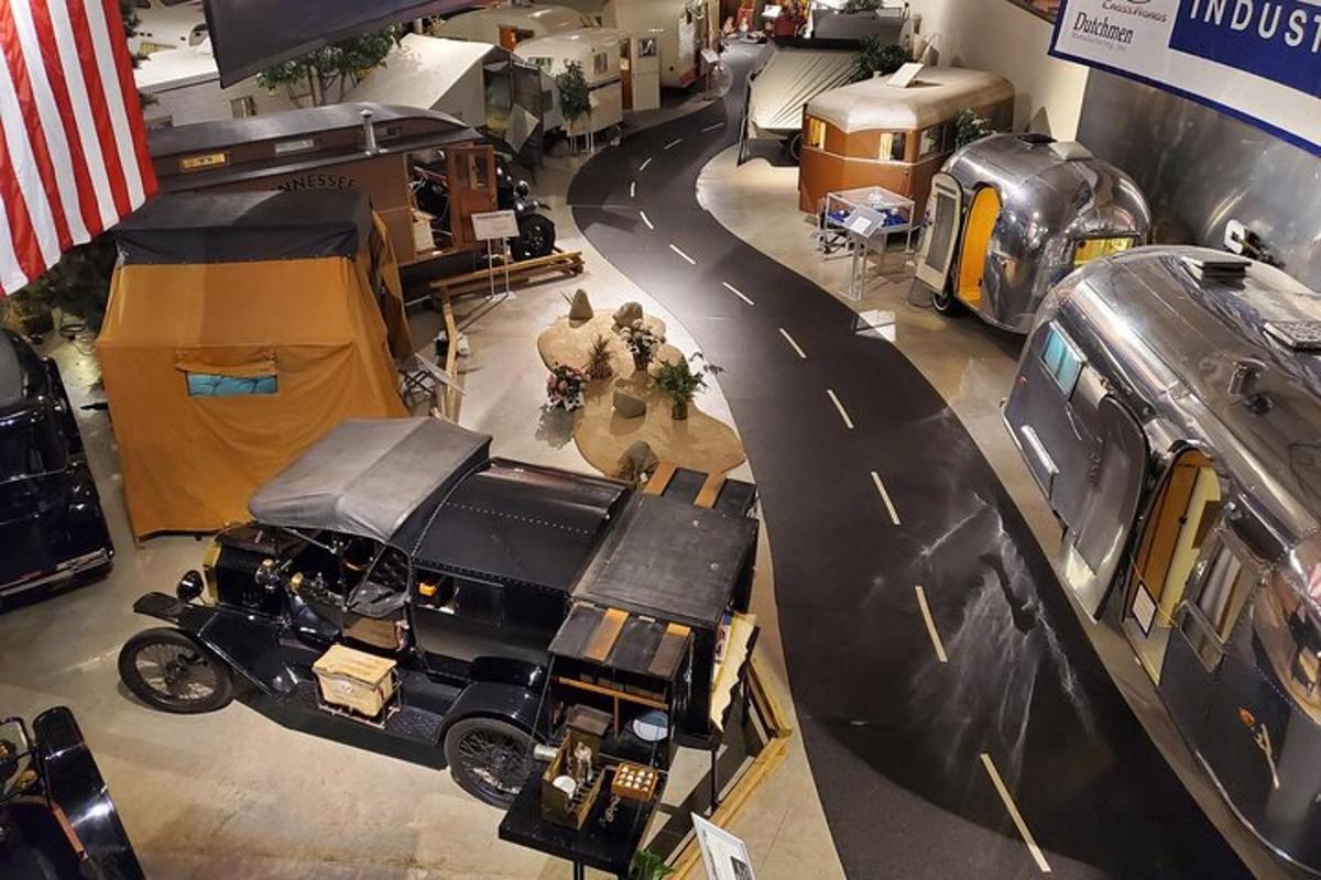an overhead view of a car dealership with a road