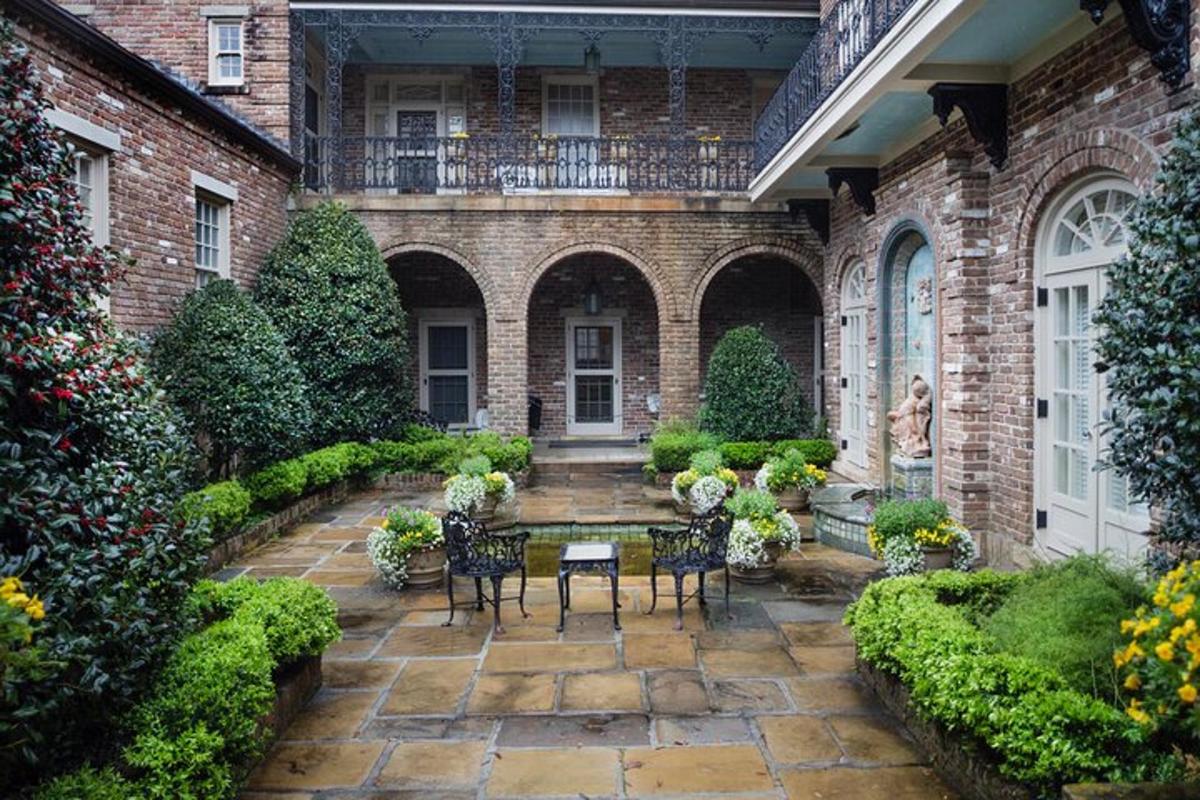 a patio with chairs and a table in front of a building