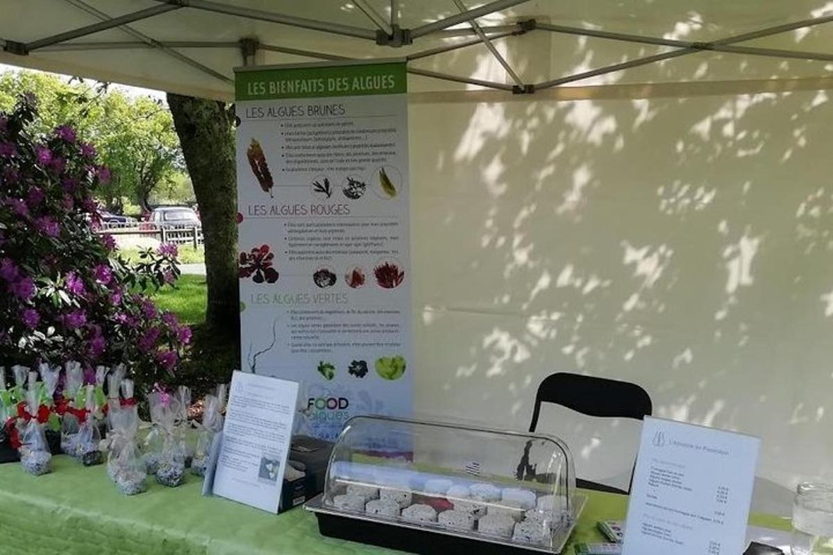 a table with a green table cloth with a display of flowers