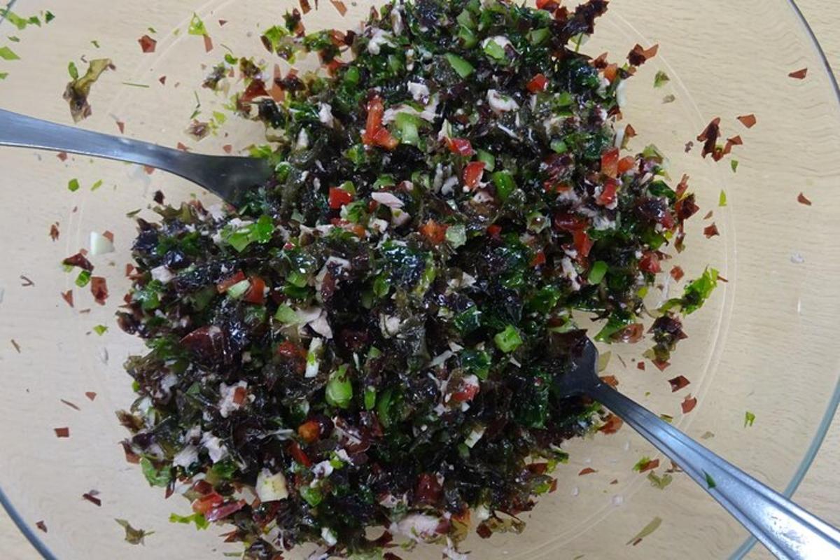 a pile of food on a plate with two spoons