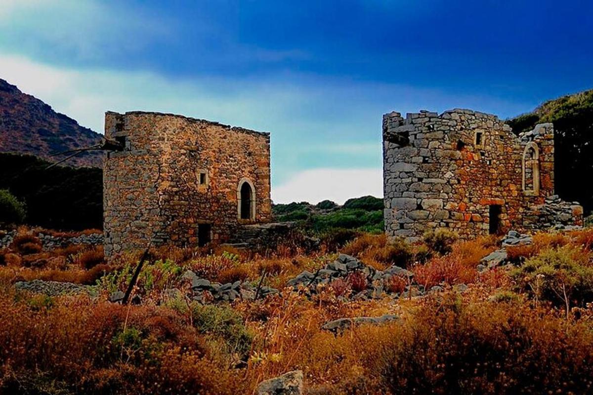 an old stone building in the middle of a field