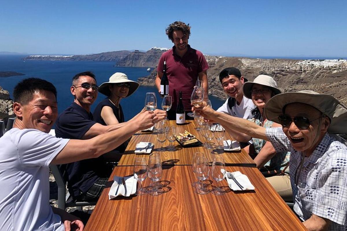 a group of people sitting around a table with wine glasses