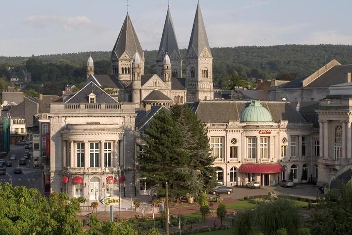 a large white building with pointed roofs in a city