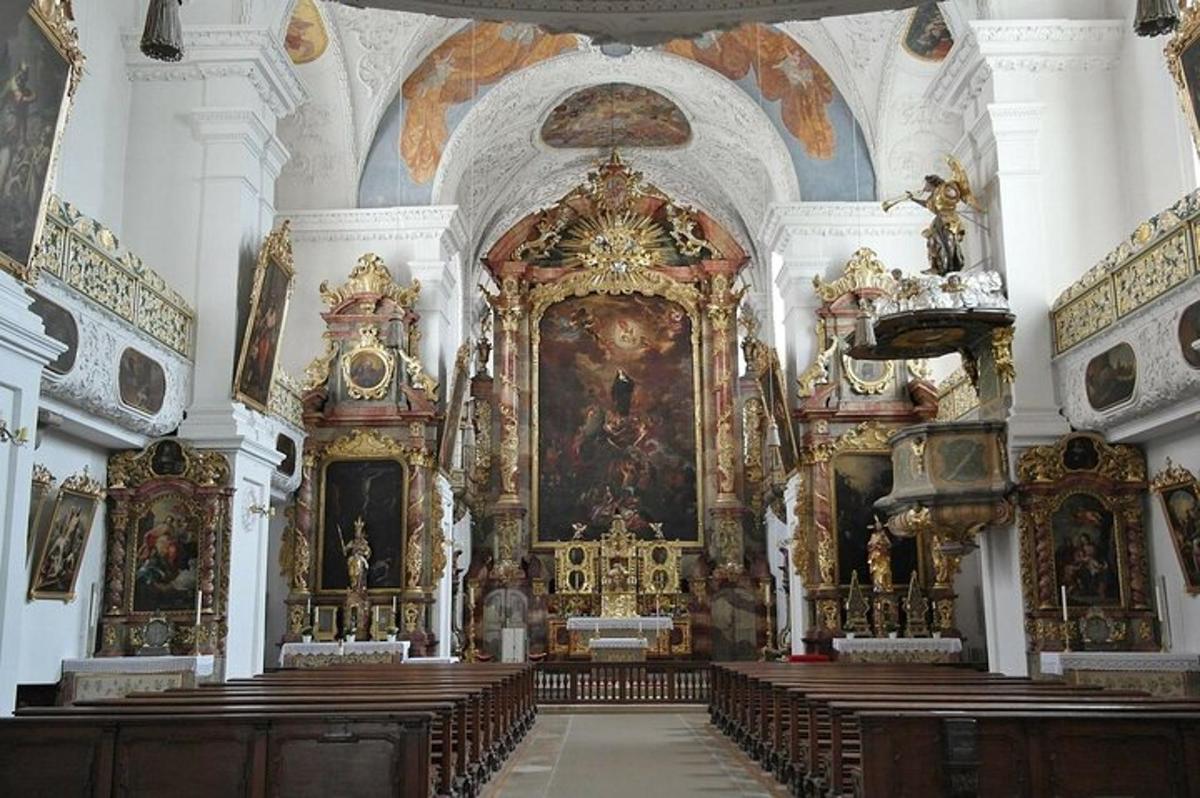a church with a large altar with paintings on the walls