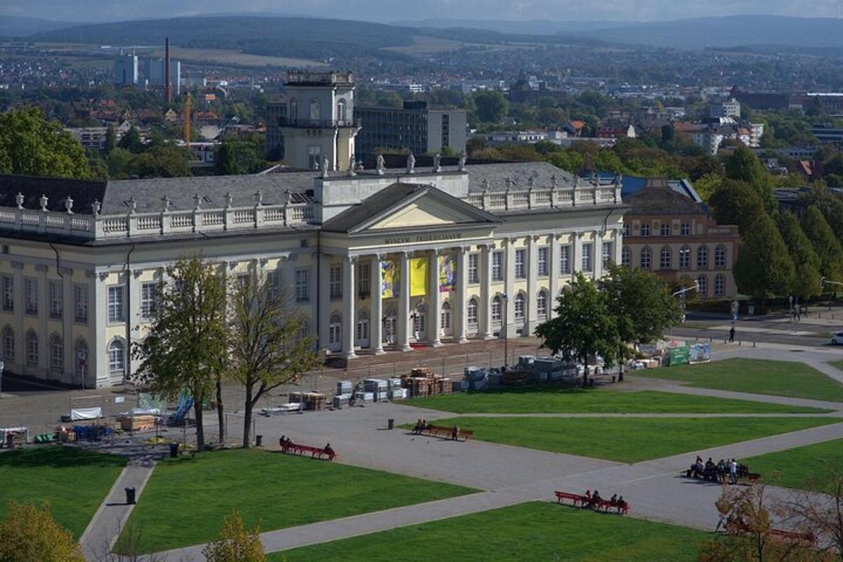 a large building with a park in front of it