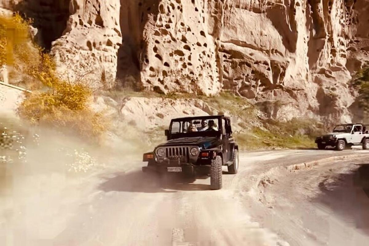 a jeep driving down a dirt road