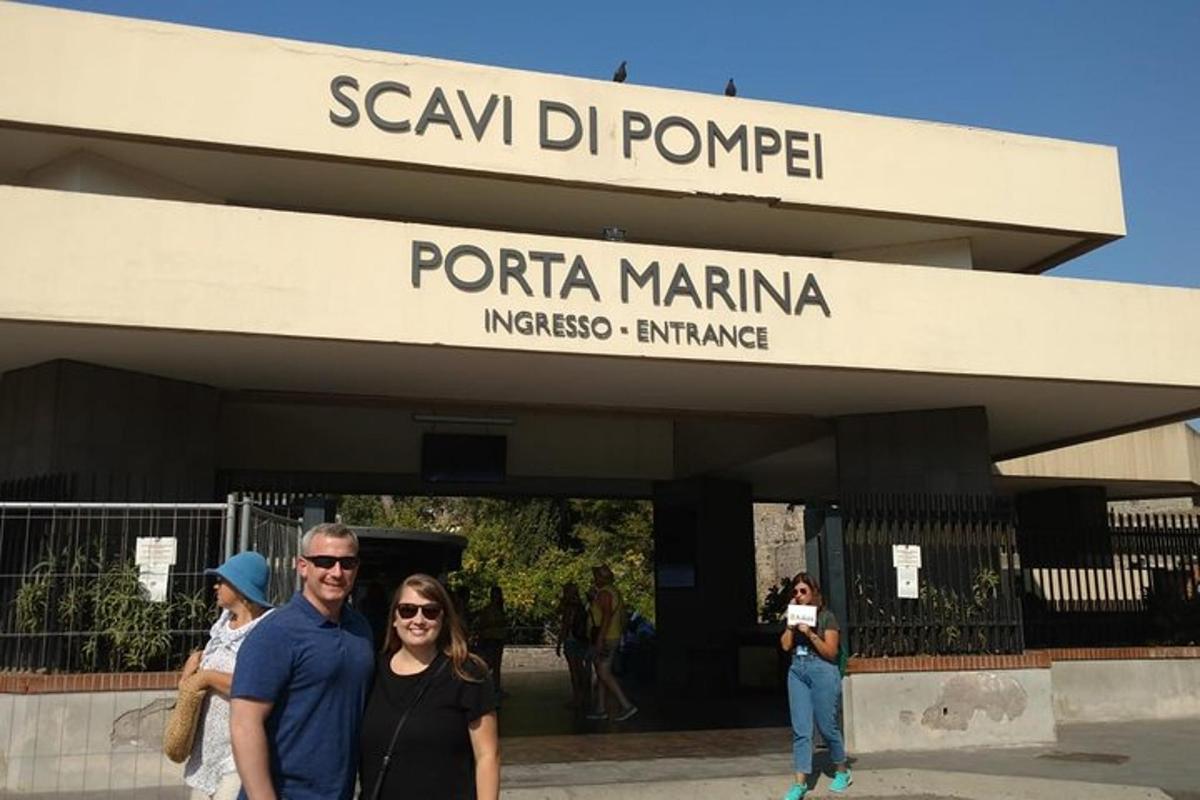 a man and a woman standing in front of a building