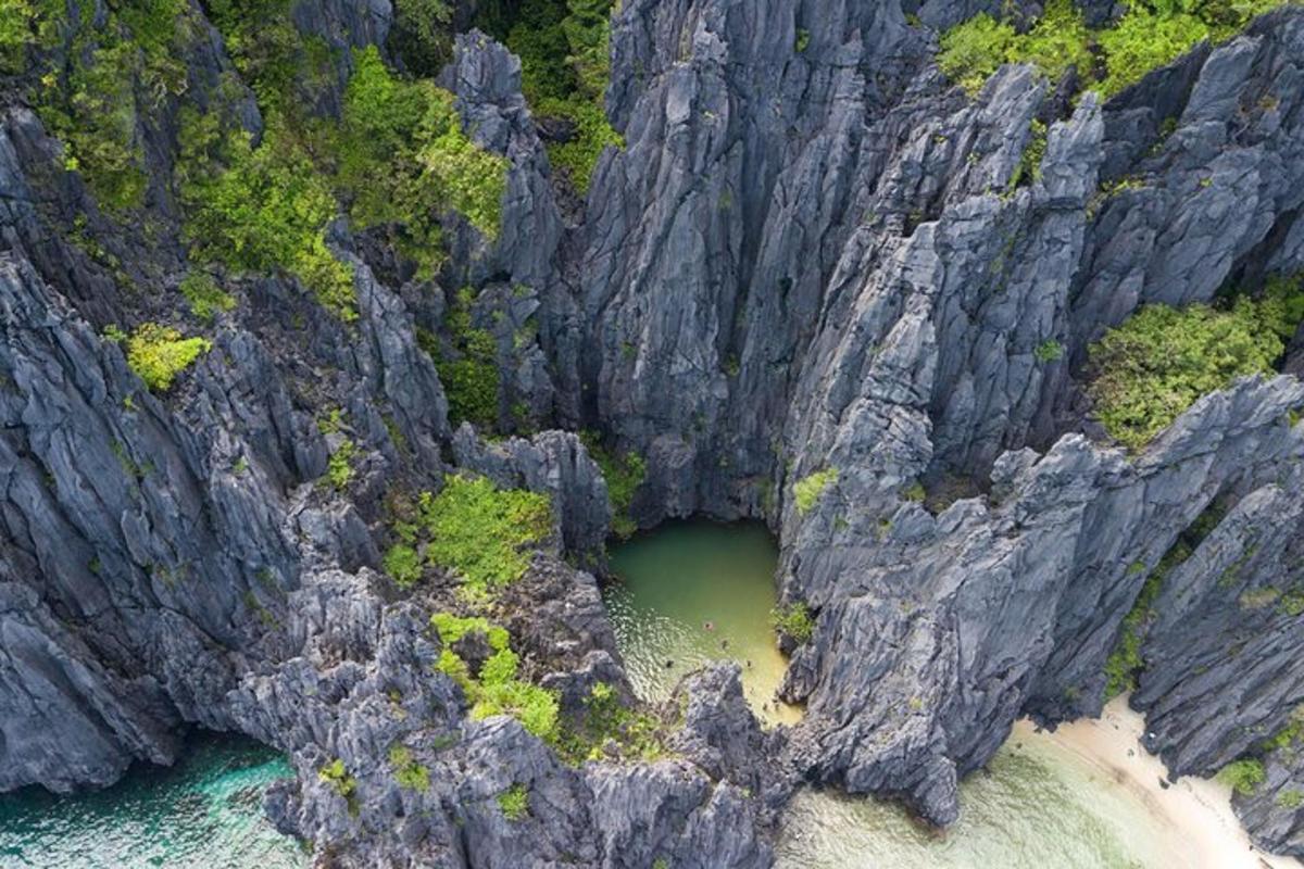an aerial view of a rocky mountain with a body of water