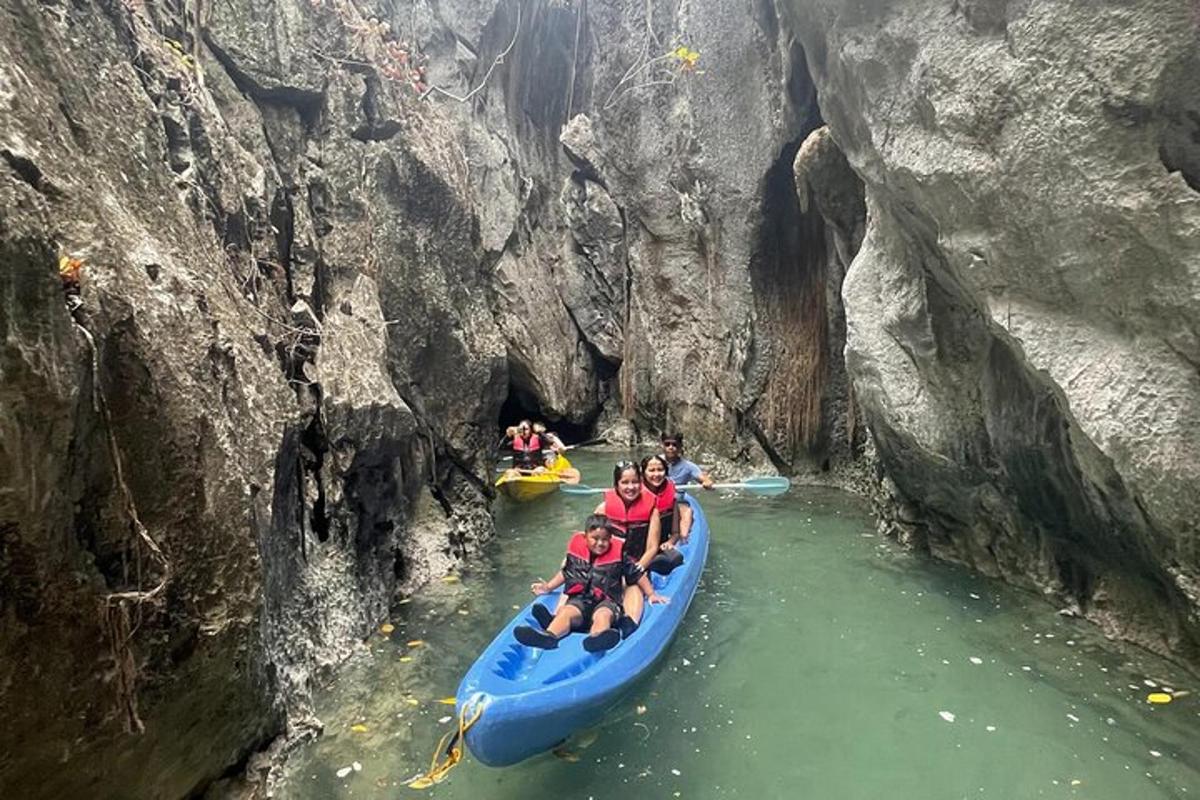 a group of people riding on a blue raft in a cave