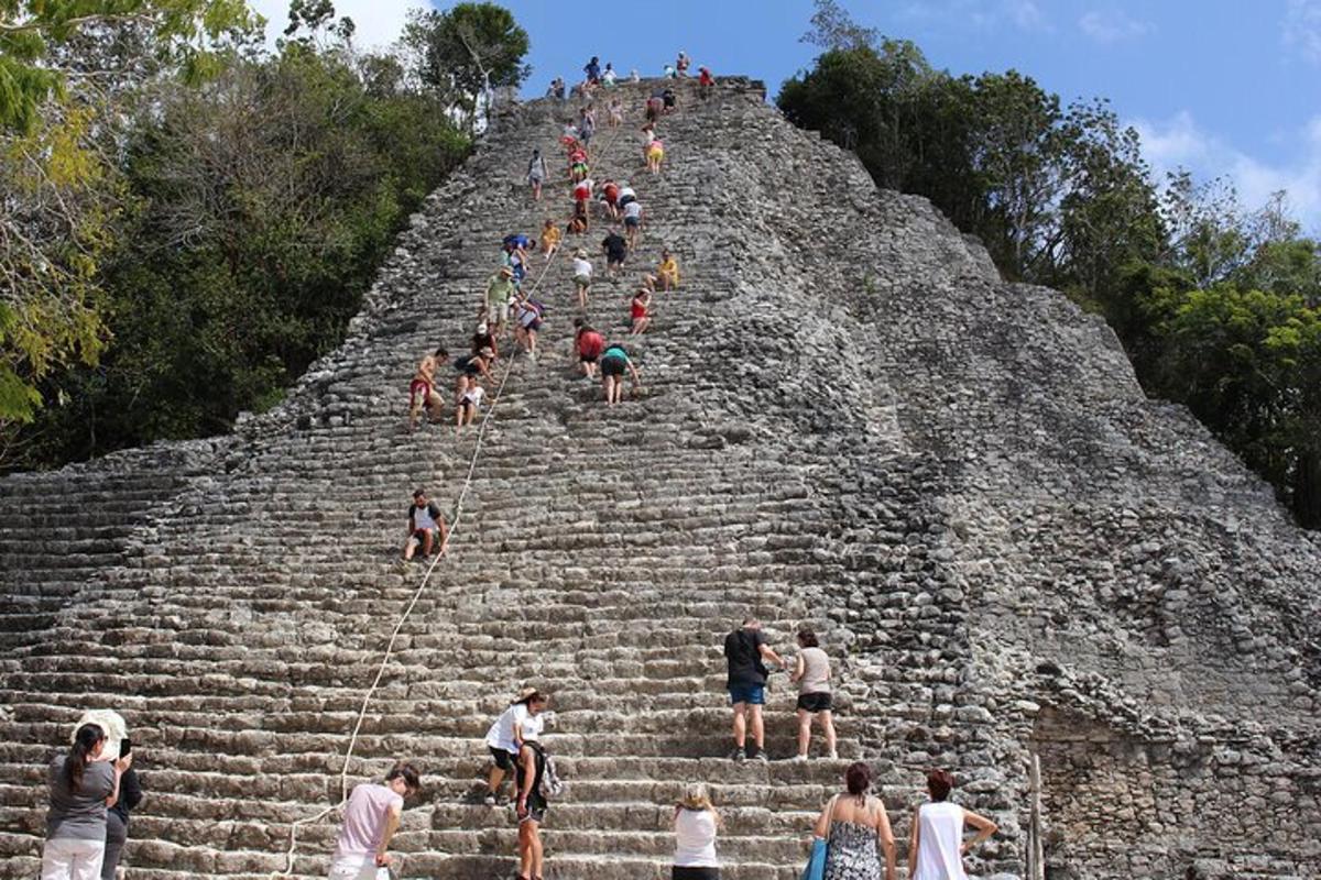 a group of people climbing up the pyramid