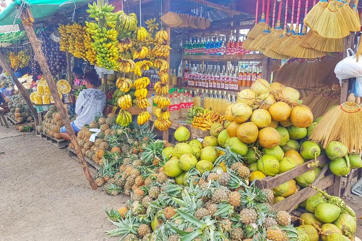a fruit stand with bananas and other fruits and vegetables