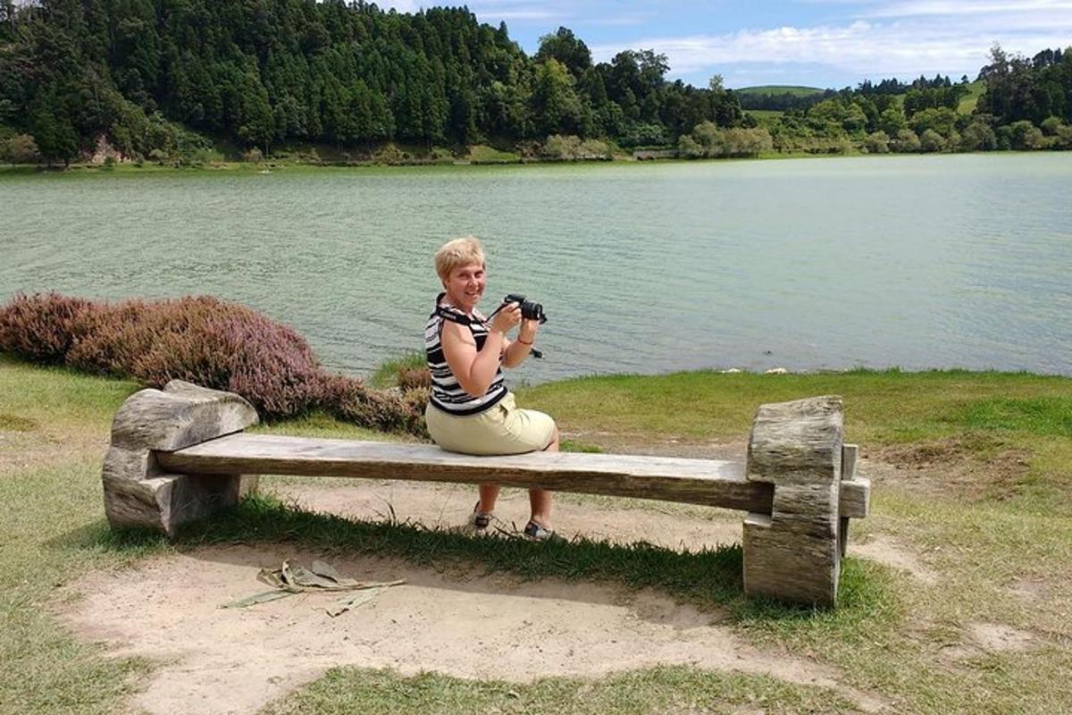 žena sedící na lavičce s fotoaparátem
