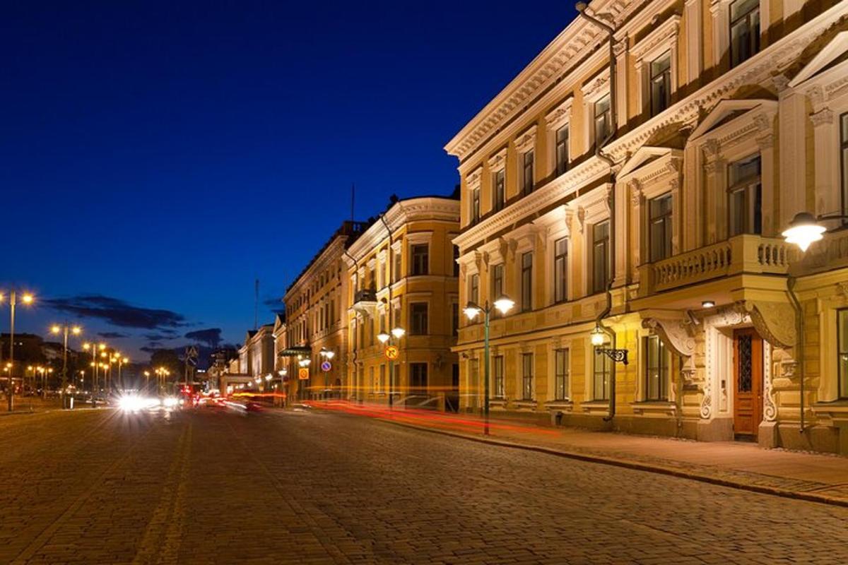 an empty street at night with buildings and street lights
