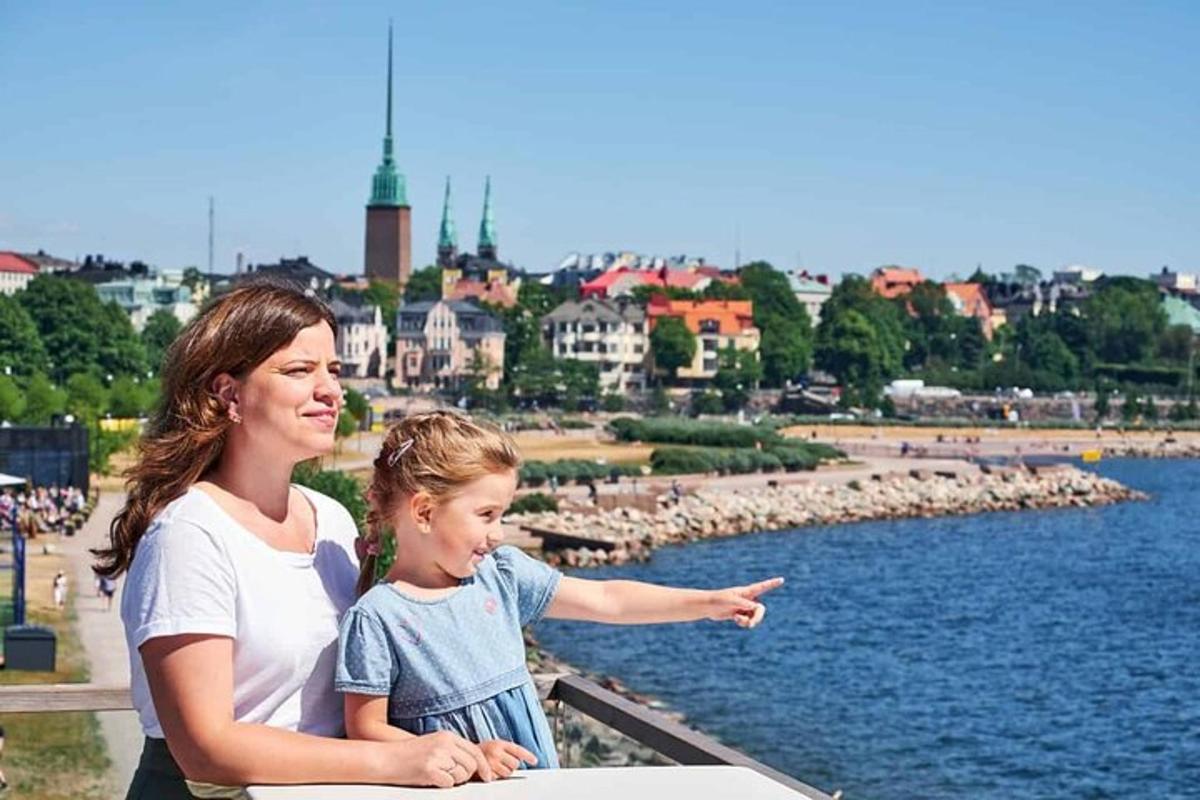 a woman and a little girl pointing at the water
