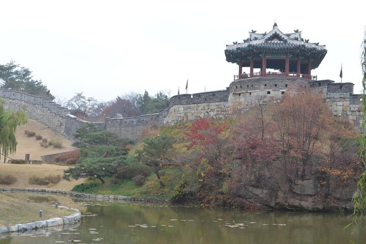 a building on a hill next to a river