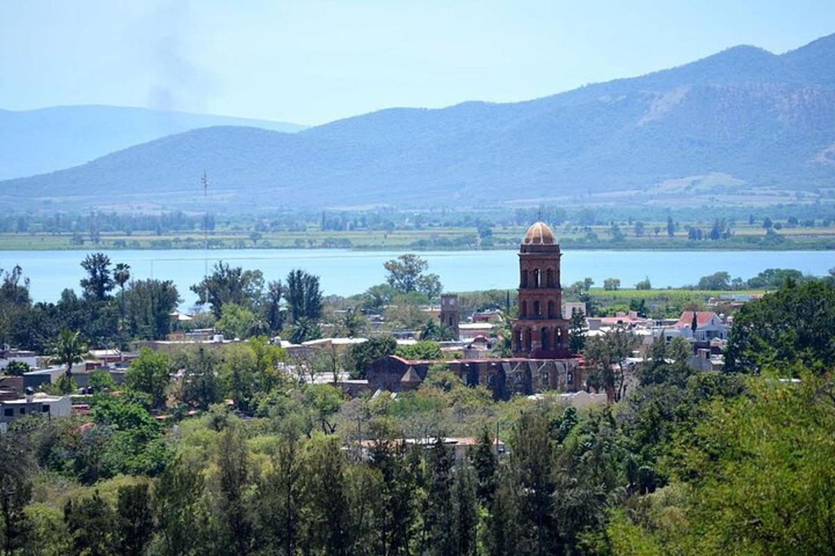 a city with a clock tower in front of a lake
