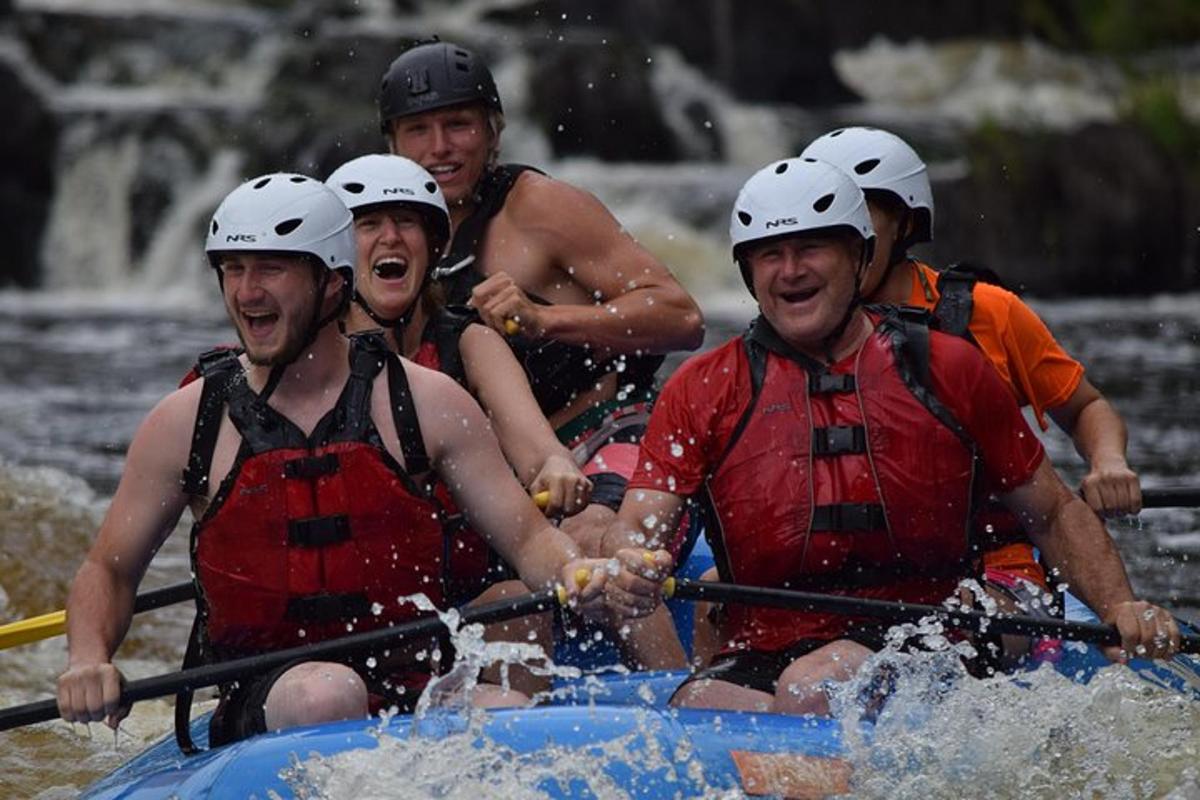 a group of people in a raft in the water