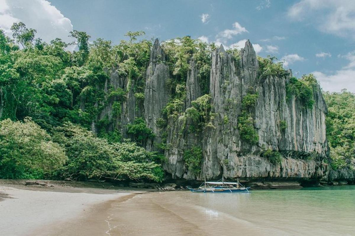 a boat in the water in front of a mountain