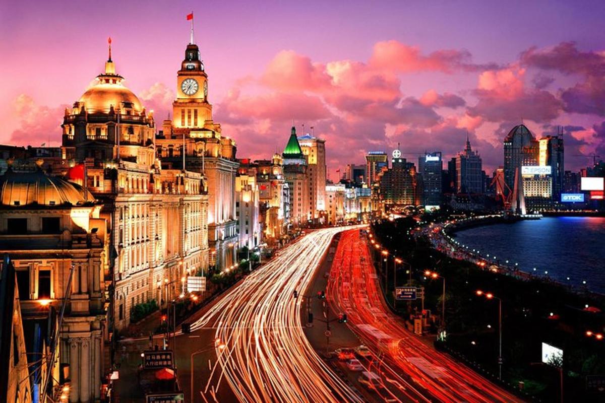 a city skyline at night with a clock tower