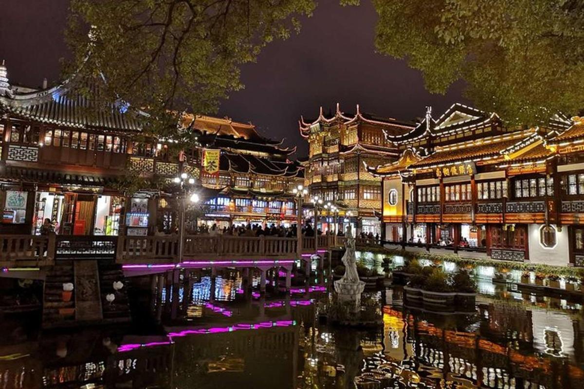 a city at night with a river and buildings