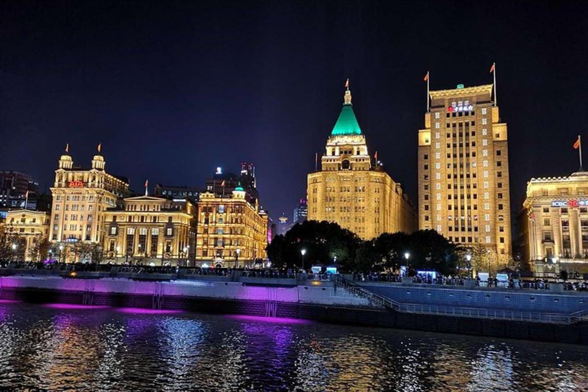 a city at night with a river and buildings