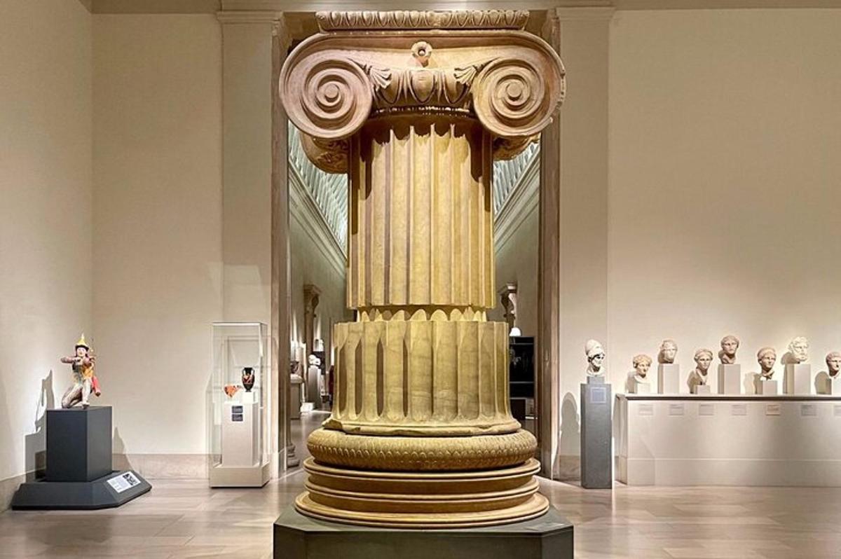 a large column in a museum with other artifacts