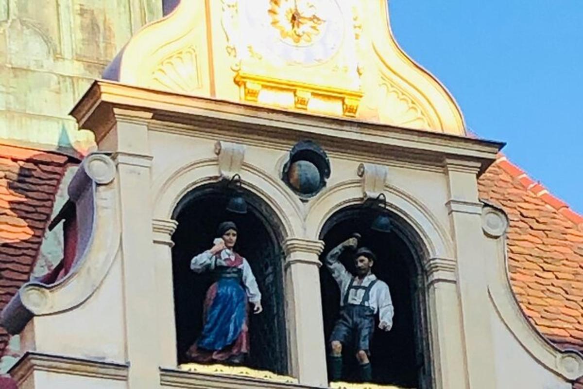 two statues of people in the windows of a church
