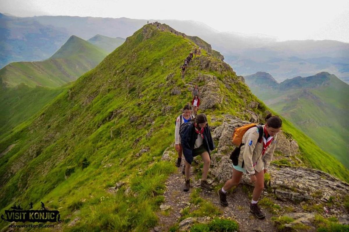 a group of people walking up a mountain