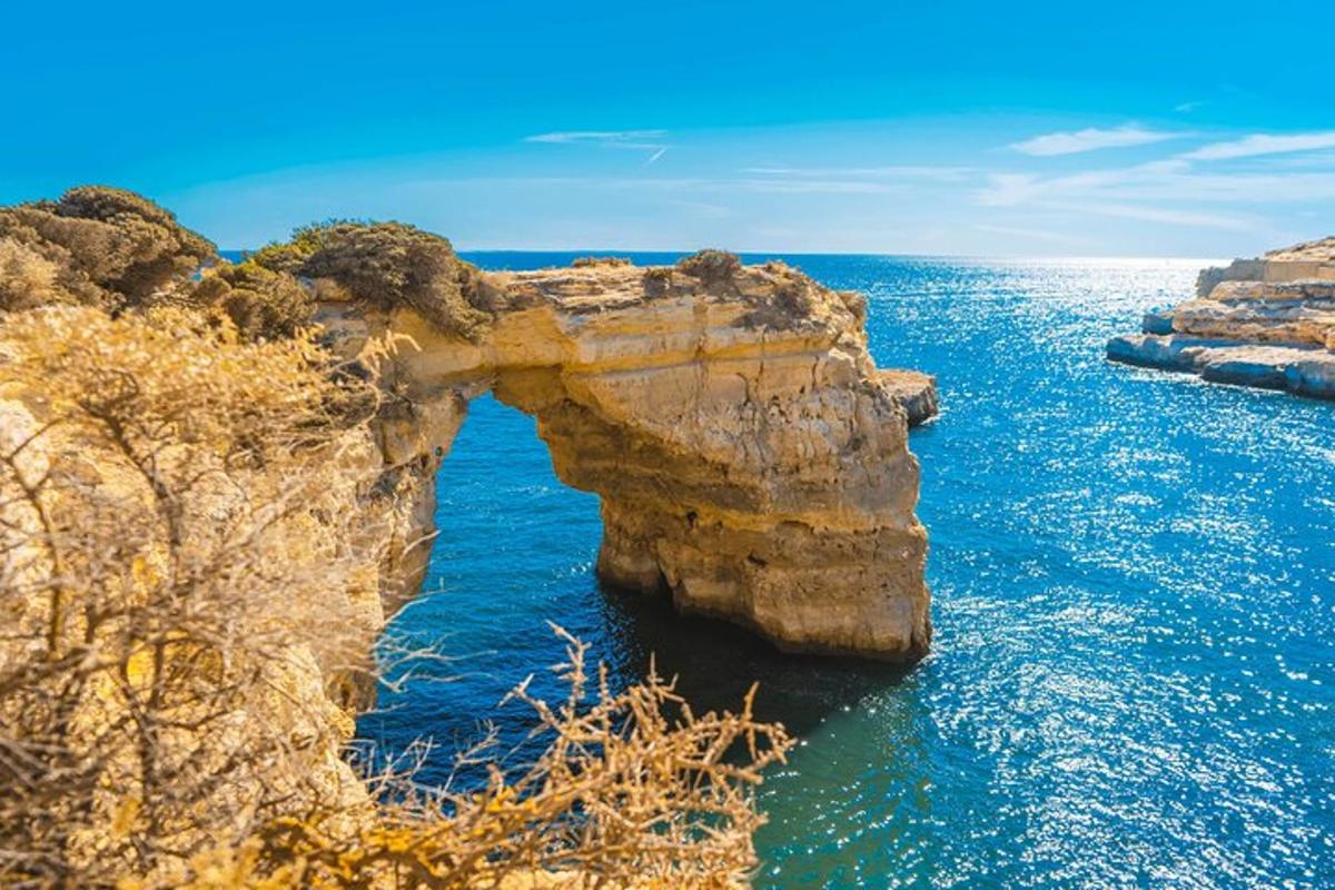 an arch in the rocks in the ocean