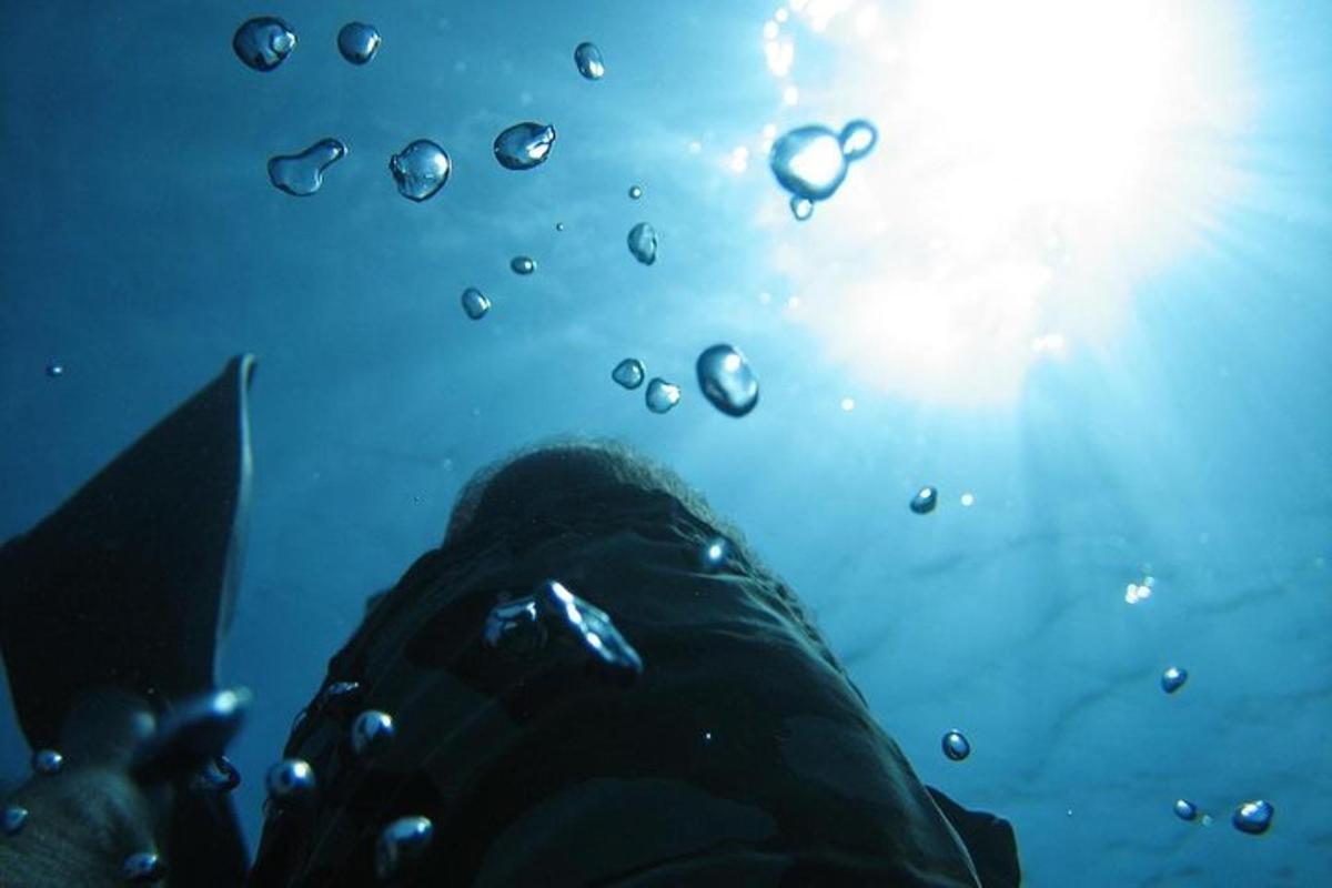 a persons foot in the water with water drops