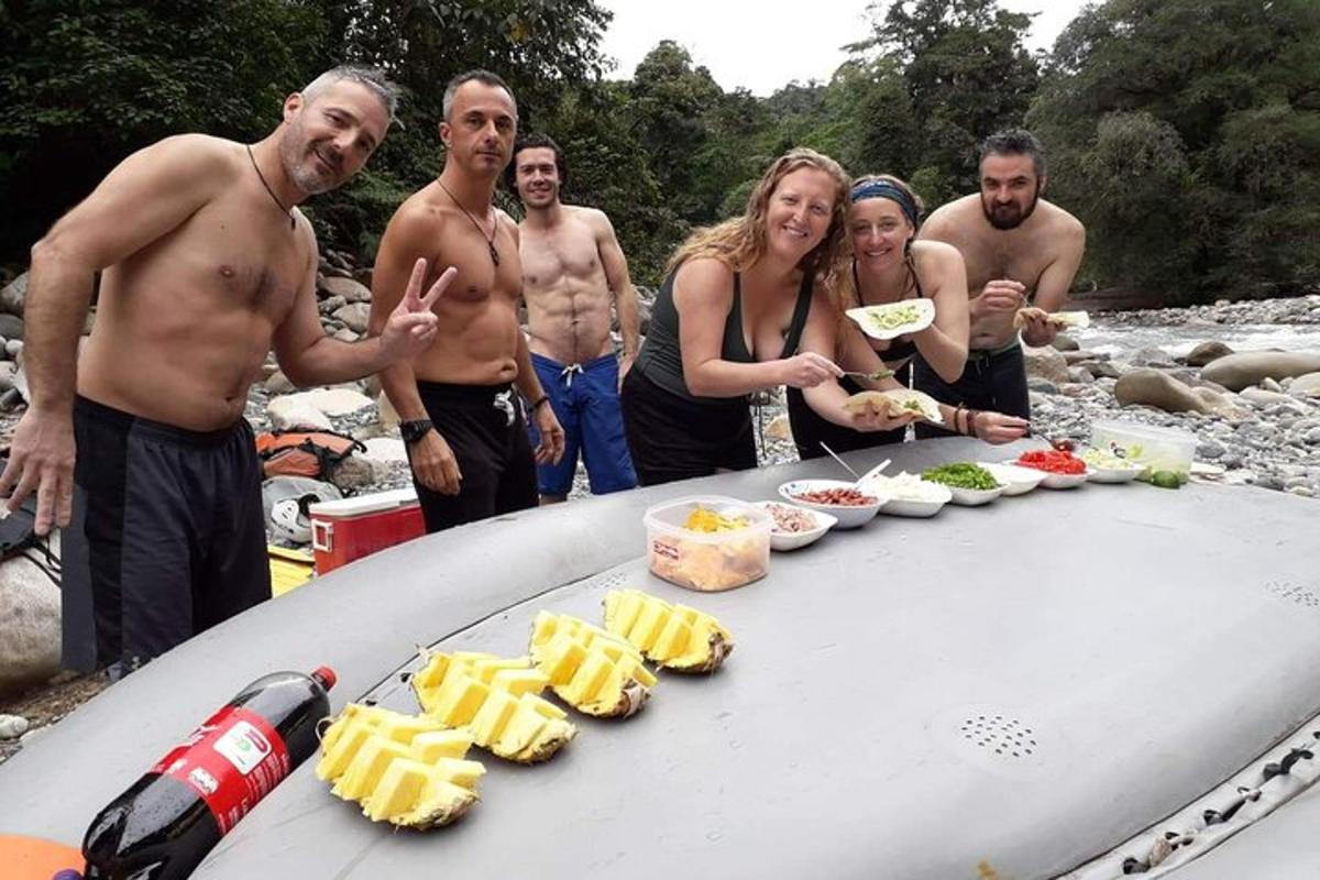 a group of people standing around a table with food on a surfboard