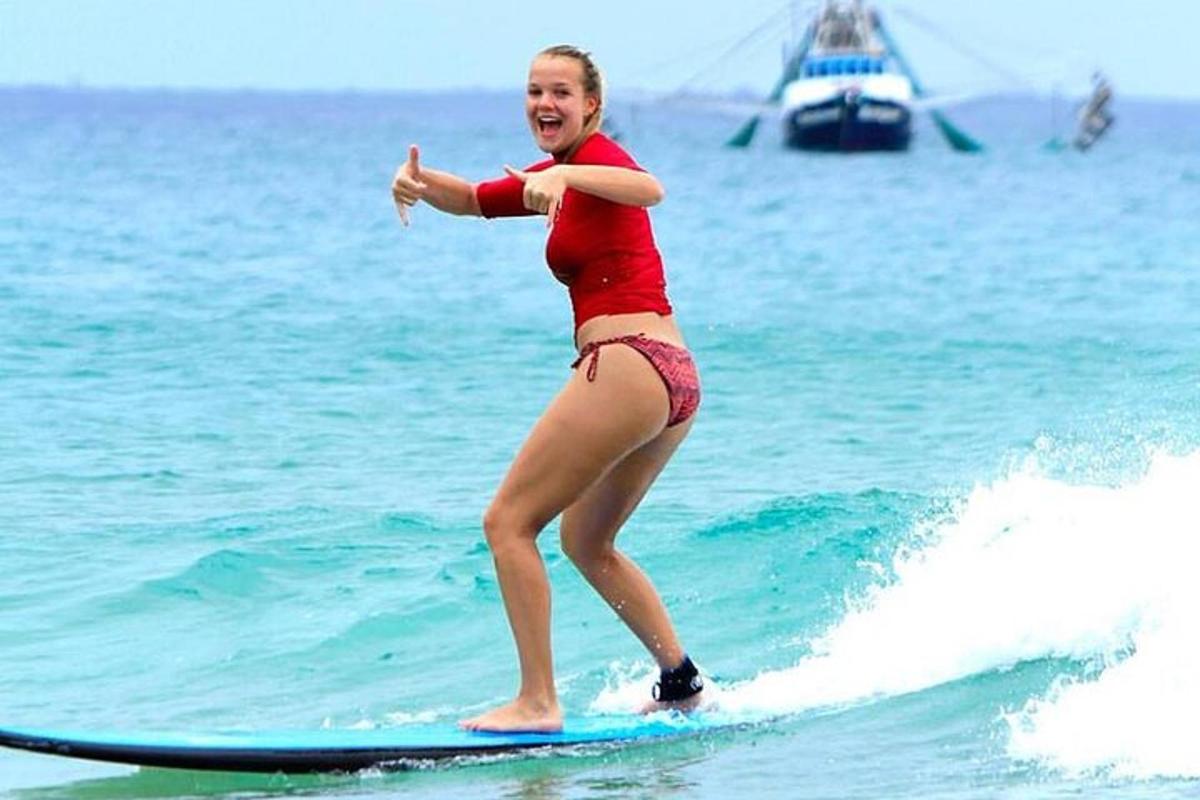 a woman riding a wave on a surfboard in the ocean