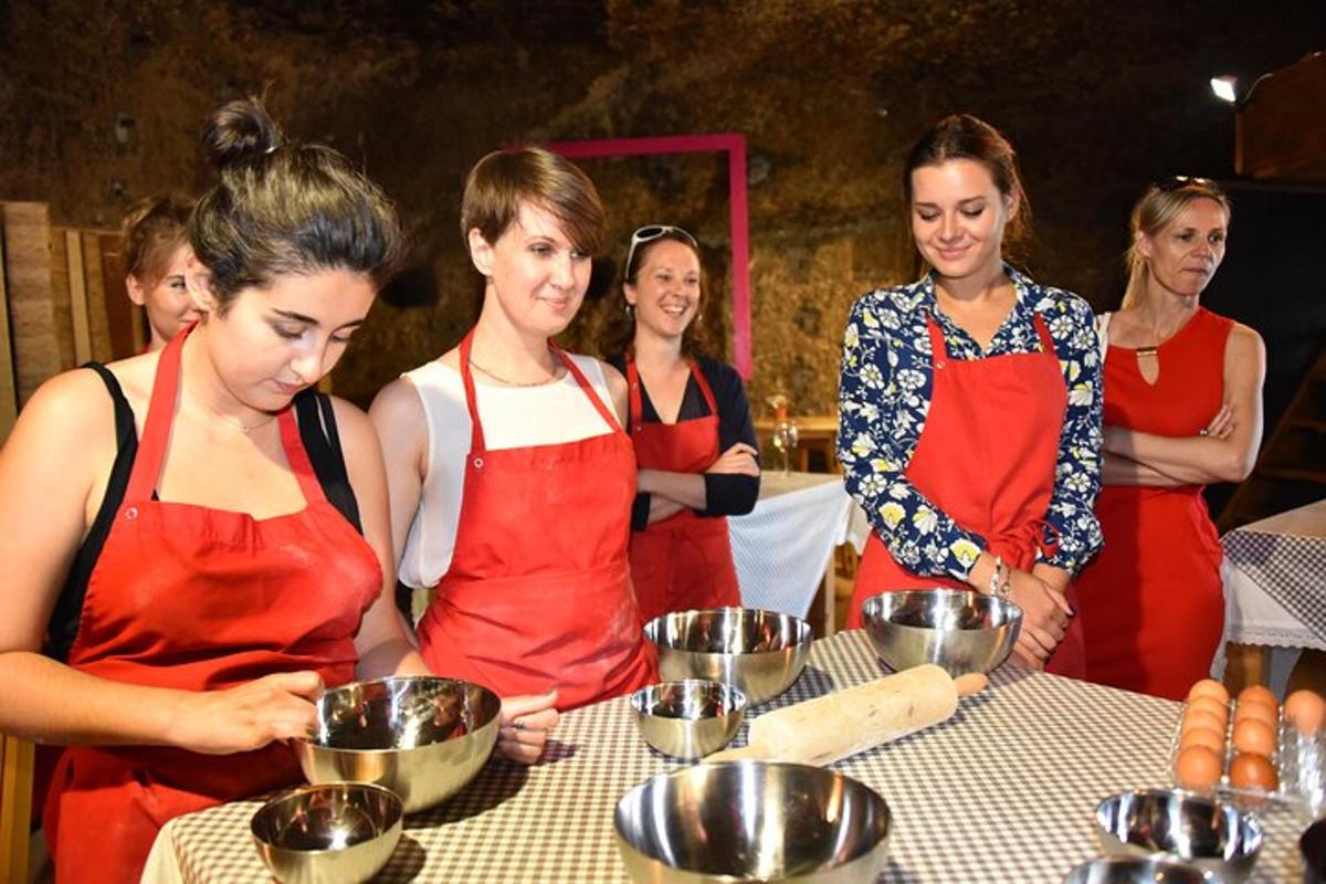 a group of women standing around a table preparing food