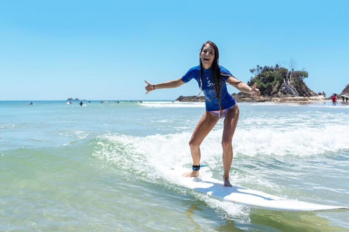a woman riding a wave on a surfboard in the ocean